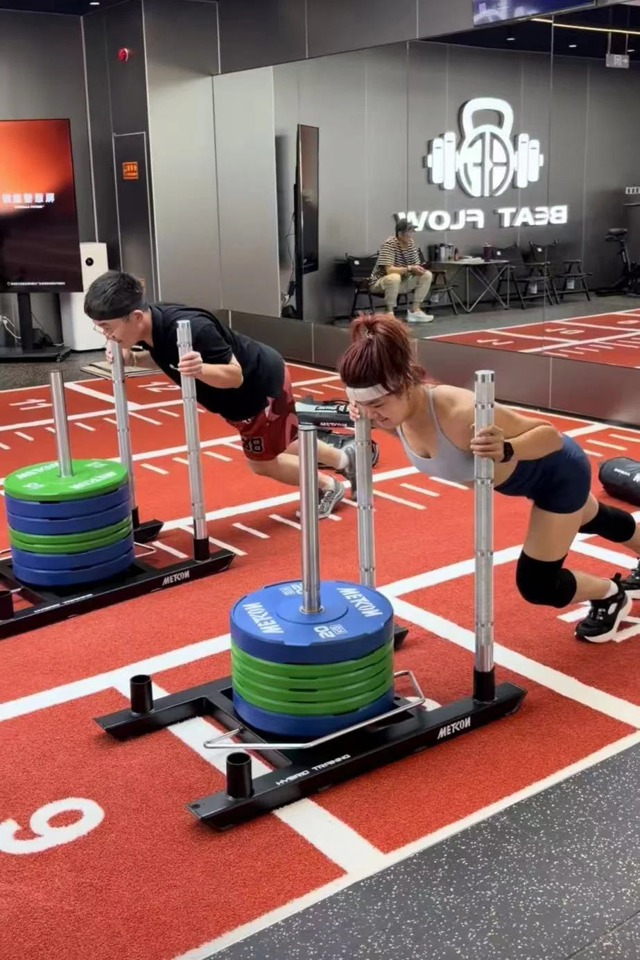 Participants wearing Nuromova headbands during a HYROX activity sled push